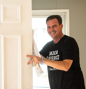 Man at Charter makes a difference day holding door